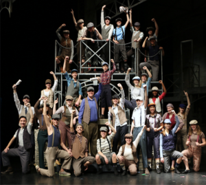 The Newsies cast recreates the photo from the original article written for the article, Newsies Stop The World, in The Sun publication. The original article was written in 1899.