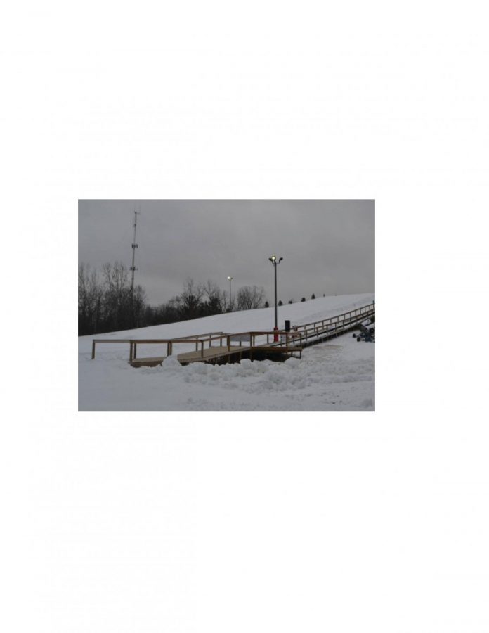 Tubers walk up this ramp carrying their tubes provied by Hawk Island. Upon reaching the top, they slide down the massive hill located in the back of the park.