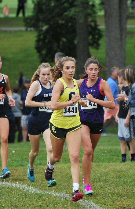 Ella Baryo, a junior on the girls cross country team, races past the competition as she looks toward the finish. She ran at Kensington Metropark on Sept. 7. 