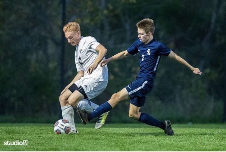 Camden Schuchaskie (right) tries to steal the ball from a defending player. Schuchaskie has recently won the LSJ Athlete of the Week award as member of the Grand Ledge Varsity Soccer team.