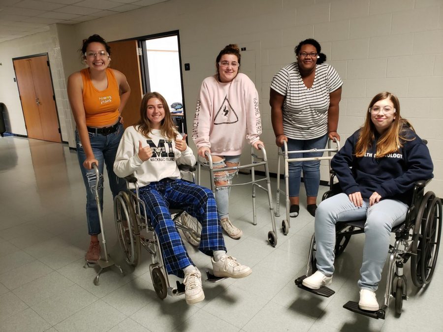 Students in the training program try out simulated disabilities. Impaired vision, and trouble walking are common  disabilities among the elderly.