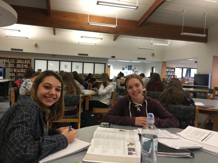 Grand Ledge High School juniors Abby Hernandez and Brianna Stange working on homework in the library. 