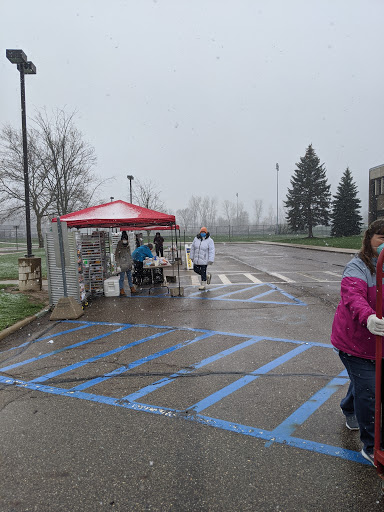 Volunteers work in all types of weather to organize food for pickup. Hundreds of families are served during the event.