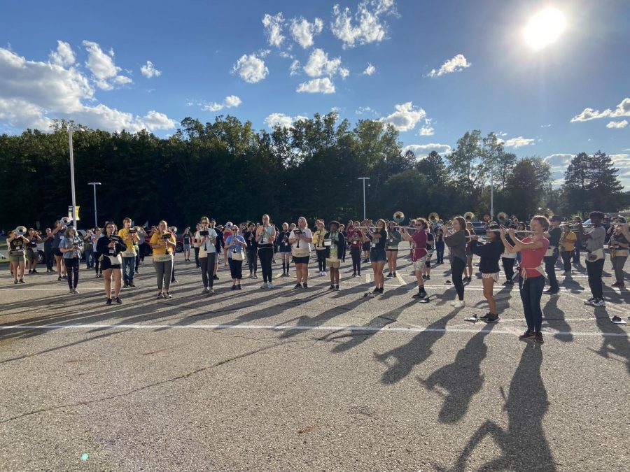 The band is currently in concert arcs practicing music. This happens multiple times along with the practices at the field.