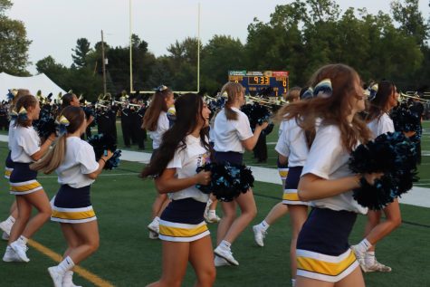 The Cheerleaders celebrate on the sidelines of the football field. This season they have participated in many events such as pep assembly, Homecoming parade and bringing the school spirit to the football games 