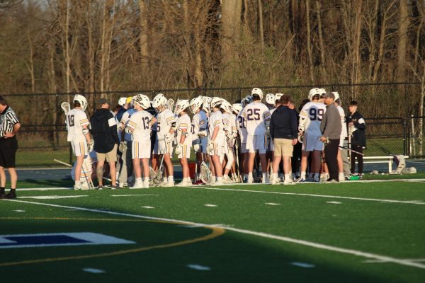 The Boys Lacrosse team gathered at the end of the quarter. Planning out a way to come back from the
score reflecting Detroit Country Day ahead.