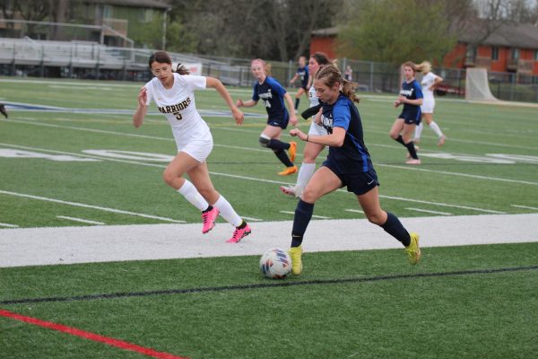 Isabel Kelly receives the ball and dribbles the ball upfield looking for an open player. The girls played Waverly and won 5-0.