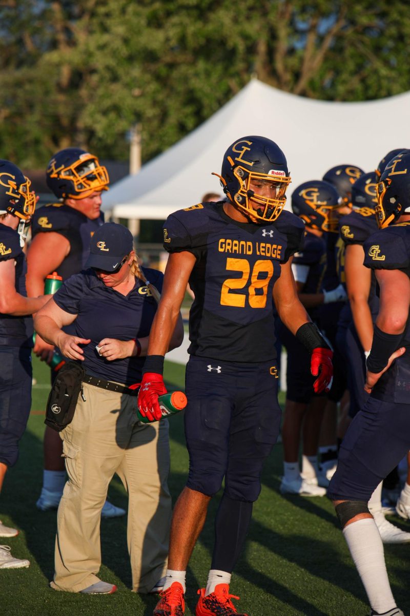 Sophomore Anthony Baker takes a drink on the sideline. He played all four quarters of the game.
Photo by: The Ledge Yearbook Staff.