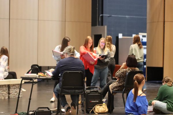 The cast members of the Mean Girls production rehearse for their show. They listened to the directors as they gave them instructions for what to do next.