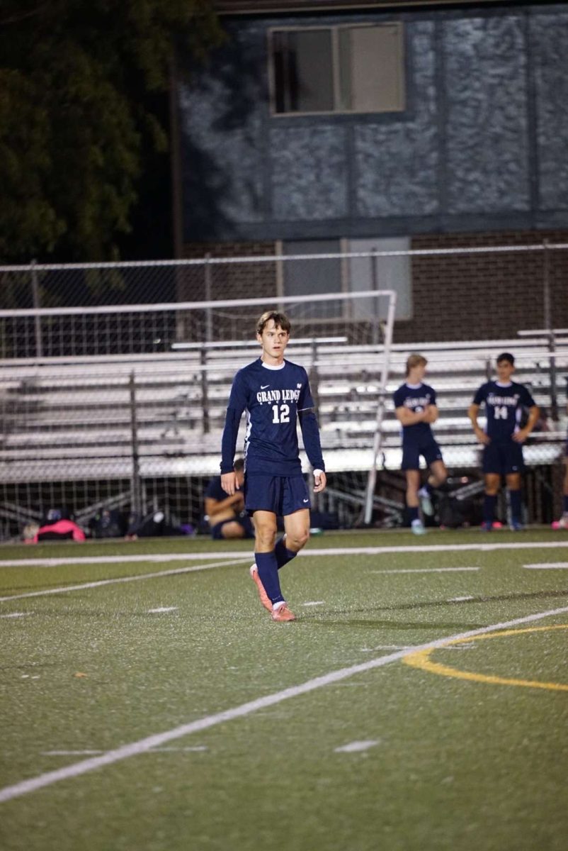 Senior Drew Buckland watches as the ball is
kicked. The game was close but the Comets won.