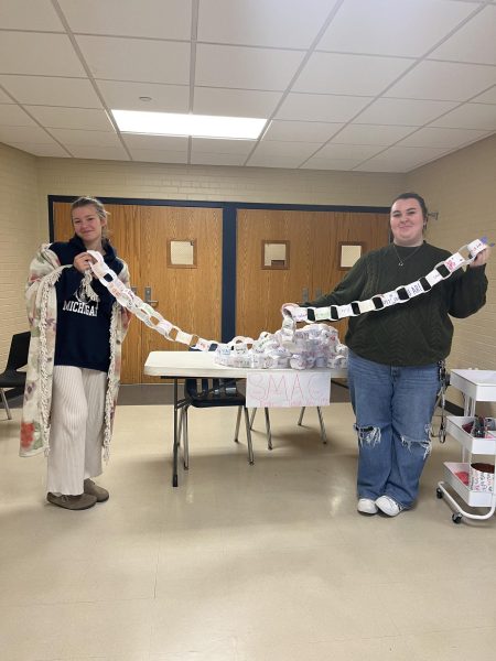 Andy Sequoia and Kyla Styles run SMAC’s words of affirmation booth. SMAC hung students affirmations at the fall school play Mean Girls. 