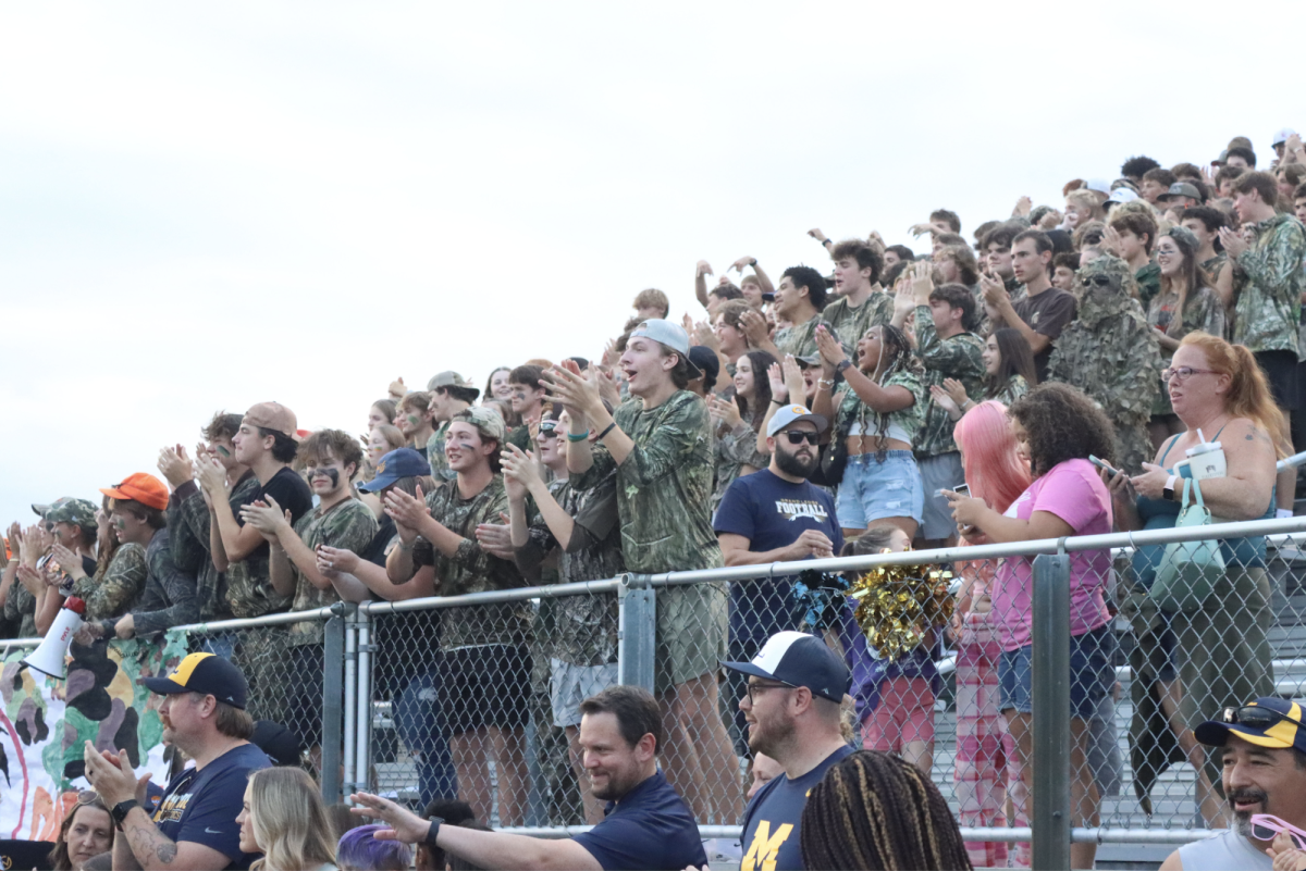 The Student Section cheers on the football team as they score a touchdown. Grand Ledge beat Holt 28-7.