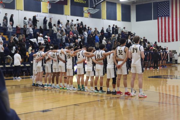 Grand Ledge Boys Varsity Basketball players line up and honor the United States National Anthem. The later went on to play East Lansing High School. 